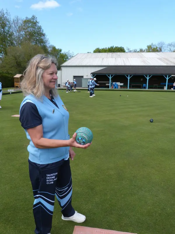 An image of a lovely lady about to play in a bowls competition.